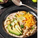 Easy Crock Pot Cream Cheese Chicken Chili in bowl with avocado and cheeese