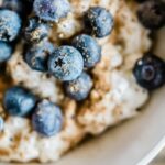 Overnight oats with blueberries in a white bowl