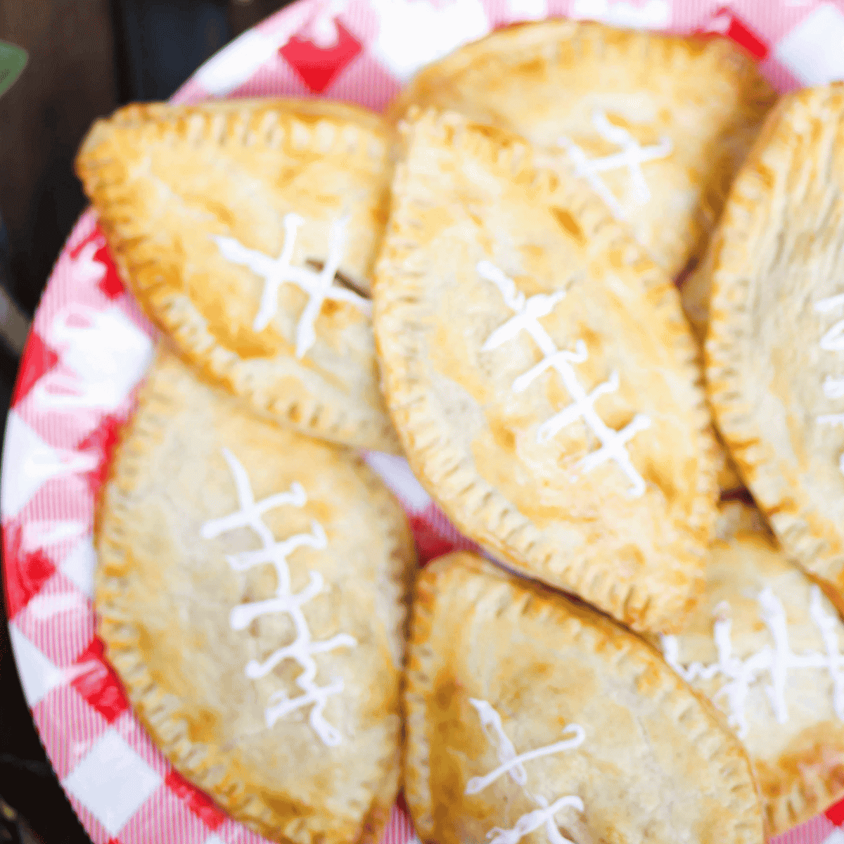 football hand pies on a red and white checkered plate.