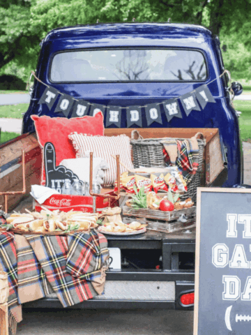 Tailgate food ideas with a game day truck setup, hot dog board, Frito bags, snack mix, and football party decorations.