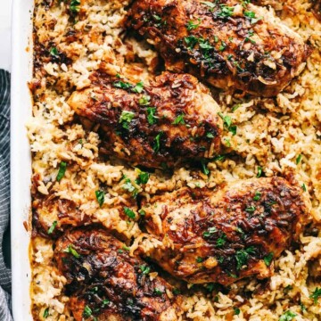 Old-fashioned chicken and rice casserole with brown chicken and savory rice, garnished with parsley, brown perfection.
