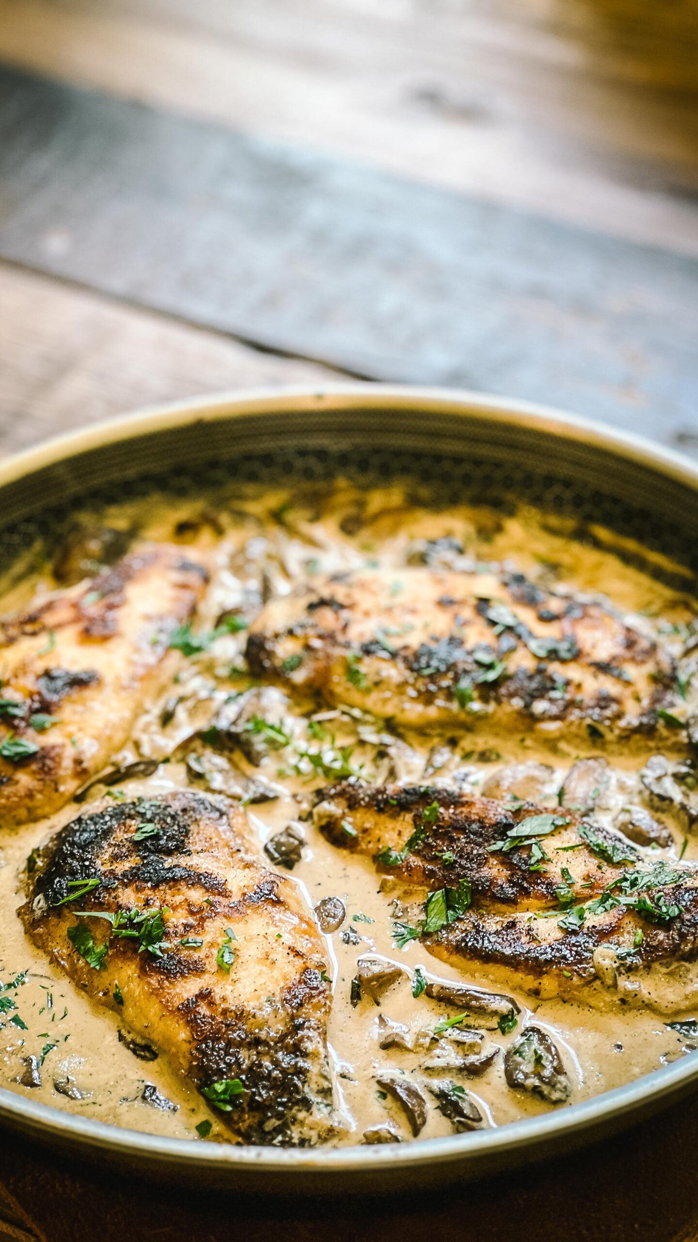 Browned chicken cutlets finishing in creamy mushroom Marsala sauce with mushrooms