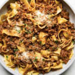 Authentic bolognese sauce recipe in a bowl with pappardelle noodles