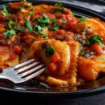 Ravioli with Marinara Sauce in bowl with fork and basil