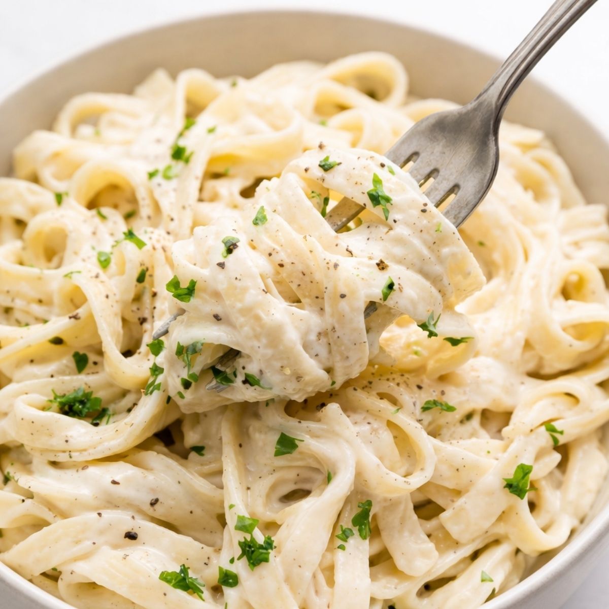 A bowl of creamy pasta with cottage cheese sauce, blended until smooth for a rich, high-protein Alfredo-style dish. Tossed with pasta and finished with fresh parsley and black pepper, this easy cottage cheese sauce creates a lighter, silky alternative to traditional cream-based sauces.