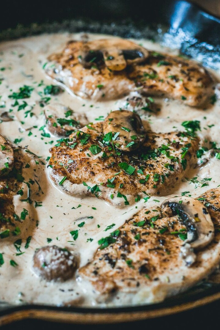 creamy parmesan chicken in cast iron skillet