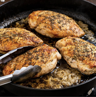 Chicken breast coated and salt and pepper and Italian seasoning, seared and butter and a cast-iron skillet.