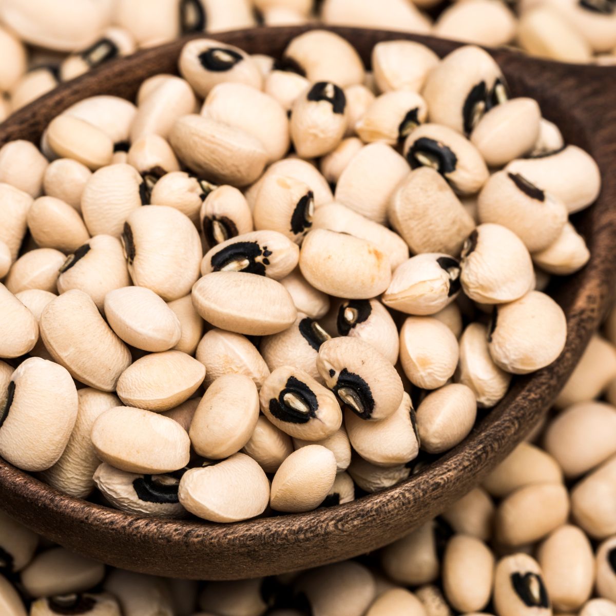 Black Eyed Peas that are dried and a wooden spoon