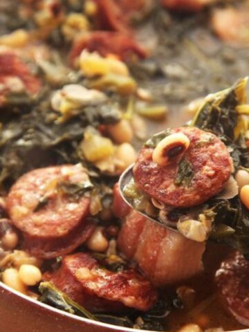 Black Eyed Peas soup with kale with a ladle and sausage