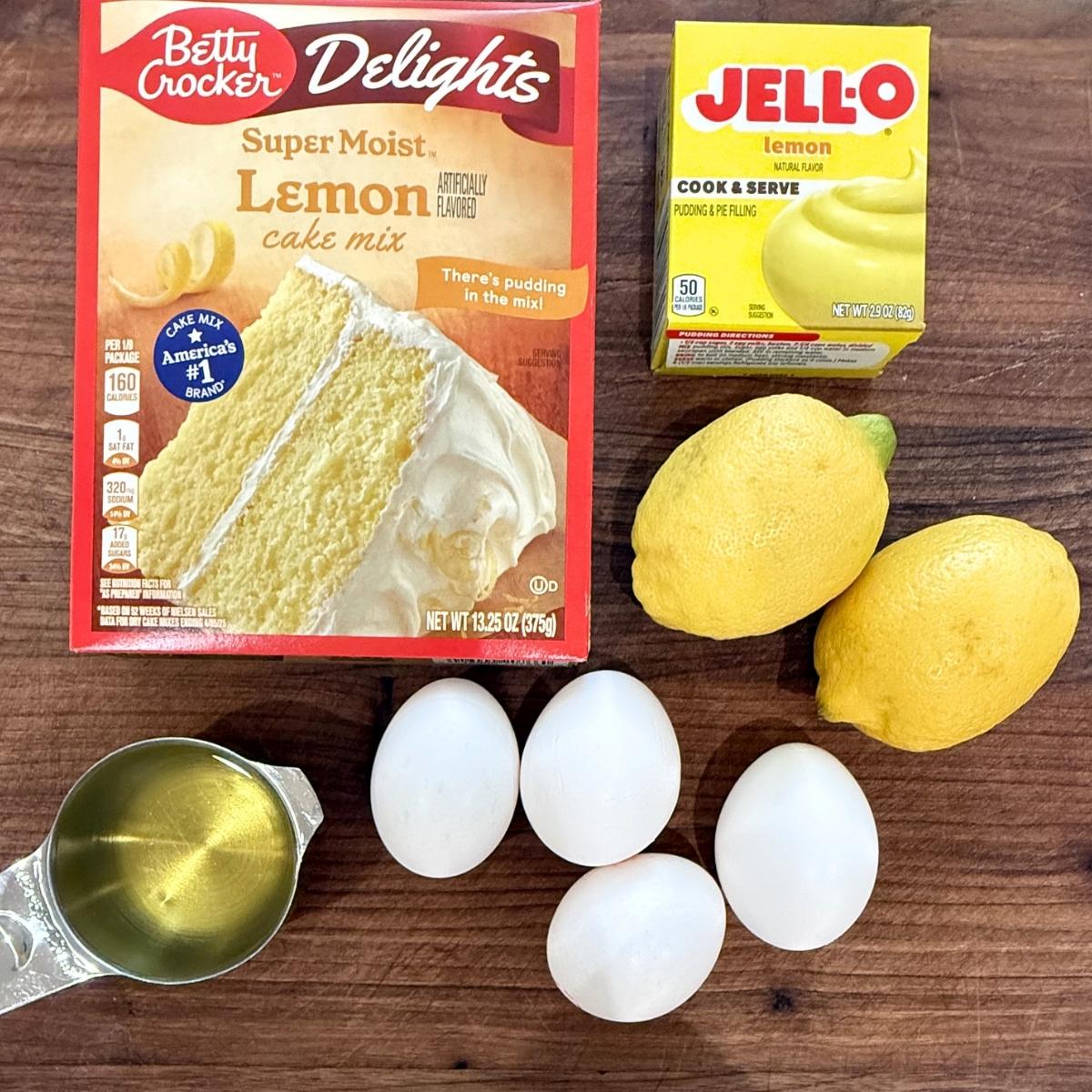 Ingredients for a lemon blueberry bundt cake on a wood cutting board.