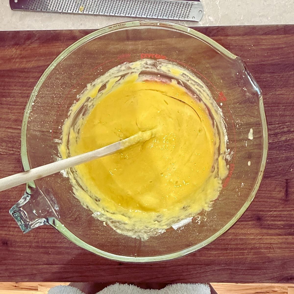 Lemon blueberry Bundt cake ingredients mixed in bowl.