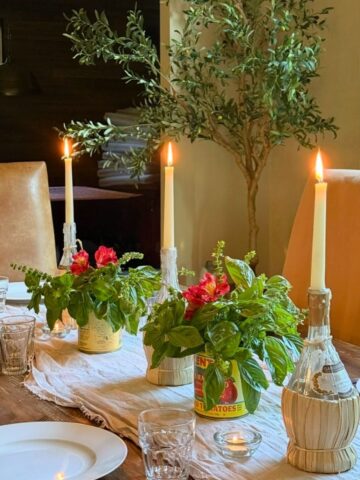 Italian dinner table setting with basil and candles
