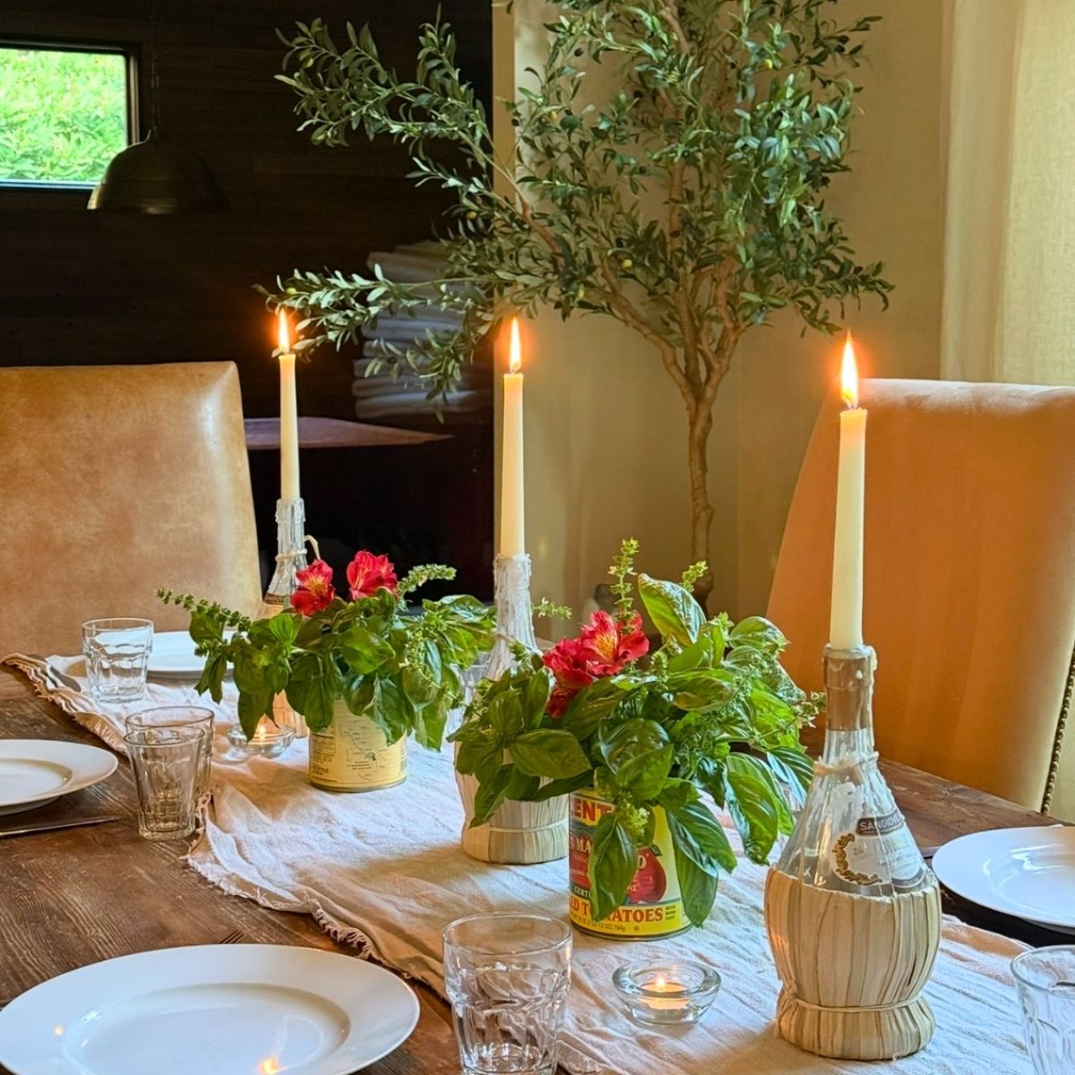 Italian dinner table setting with basil and candles