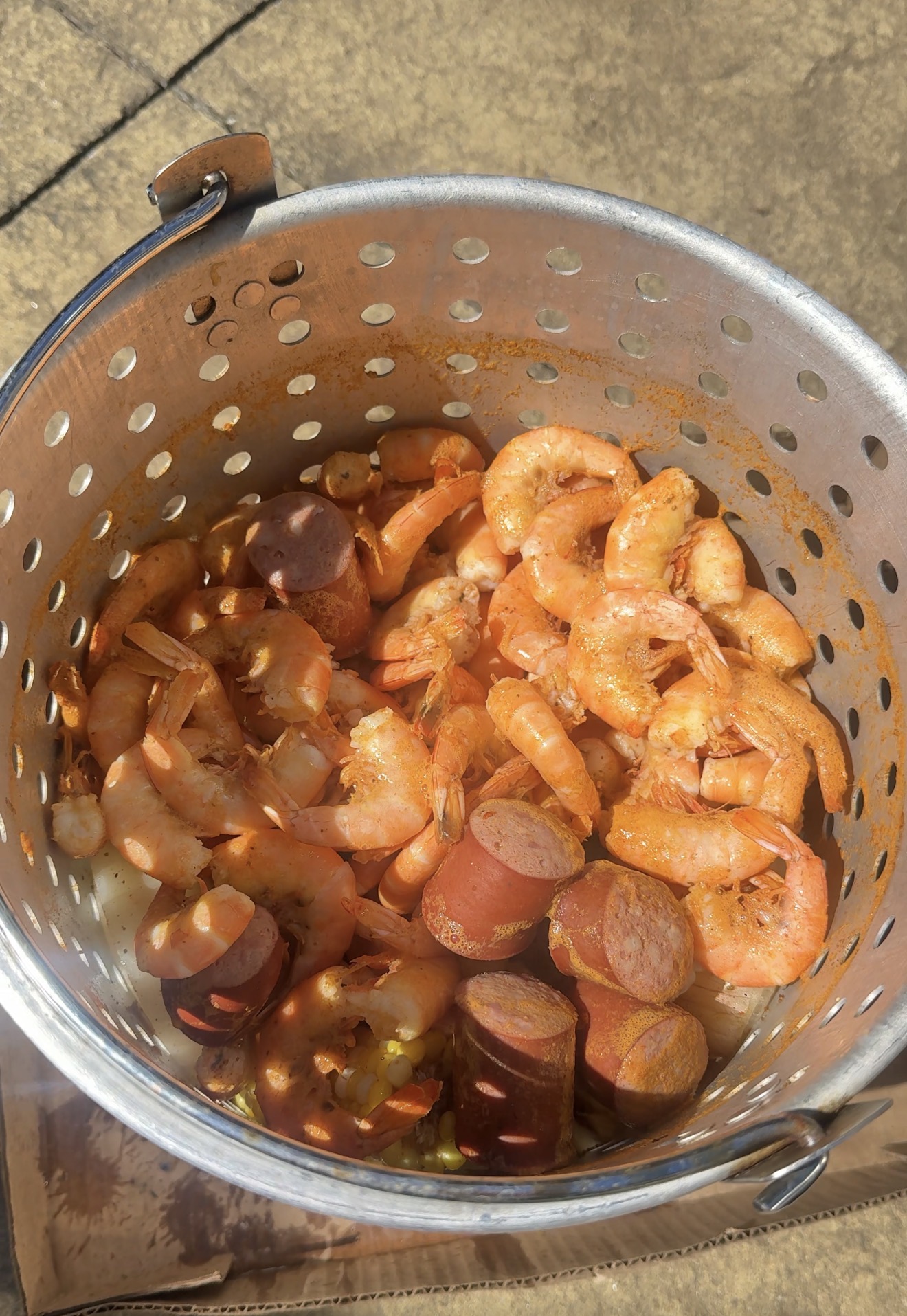 Cooked shrimp and sausage in a shrimp boil pot.