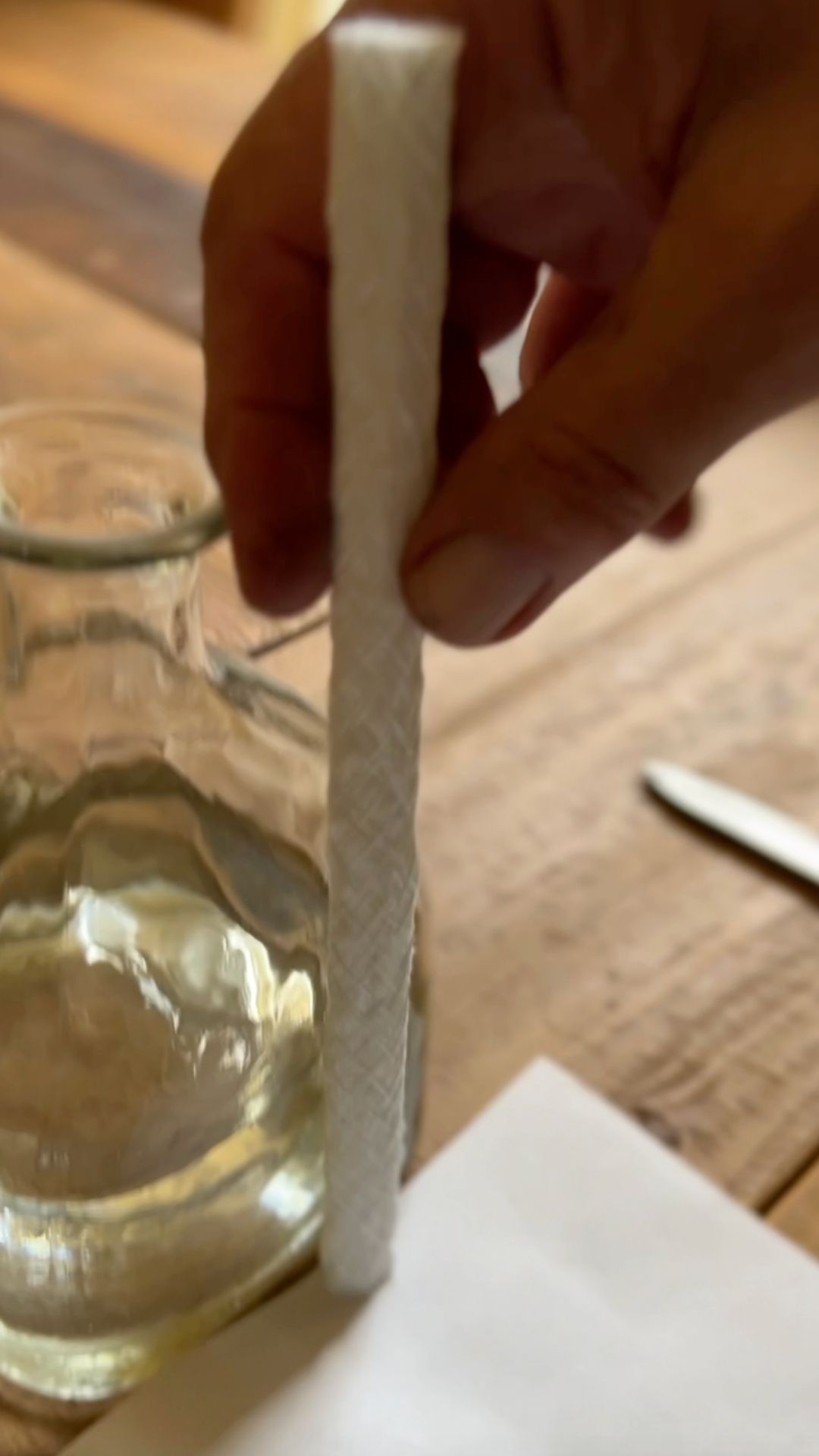 Glass bottle being turned into a DIY tiki torch